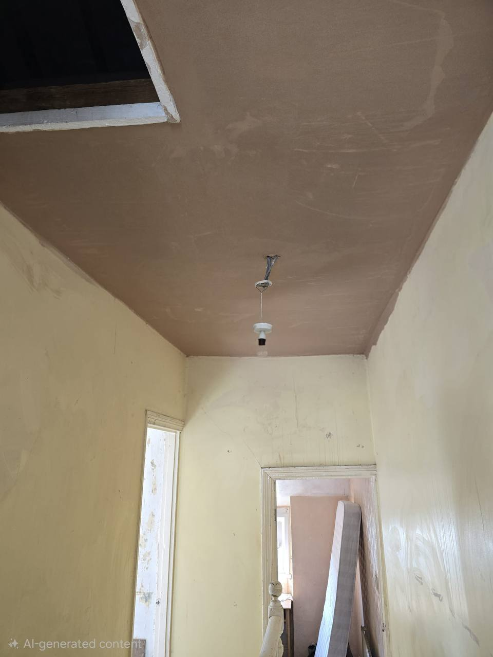 Hallway ceiling after new plaster finish in Cardiff